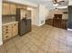 Open kitchen with stainless appliances and view to the living room with fireplace at 6606 Antrim Ct, Charlotte, NC 28217