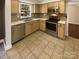 Bright kitchen featuring tile floors, stainless appliances, and tile backsplash at 6606 Antrim Ct, Charlotte, NC 28217
