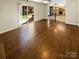 Spacious living room with wood floors flowing into a modern open kitchen concept at 6606 Antrim Ct, Charlotte, NC 28217