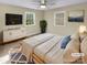 Cozy staged bedroom with a ceiling fan, a bright window, and neutral décor at 6813 Linda Lake Dr, Charlotte, NC 28215