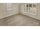 Cozy bedroom with neutral carpet, three windows with blinds, and ample natural light at 6813 Linda Lake Dr, Charlotte, NC 28215