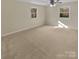 Bedroom featuring neutral carpet, white trim, and two windows at 6813 Linda Lake Dr, Charlotte, NC 28215