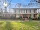 Charming two-story brick home with second story covered patio and lush front yard at 6813 Linda Lake Dr, Charlotte, NC 28215
