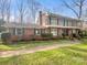 Beautiful two-story brick home with a covered porch and meticulously maintained landscaping at 6813 Linda Lake Dr, Charlotte, NC 28215