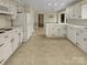 Bright kitchen features white cabinetry, tile flooring, and ample countertop space at 6813 Linda Lake Dr, Charlotte, NC 28215