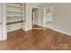 Living room with wood floors, built in shelves and a view of the kitchen at 6813 Linda Lake Dr, Charlotte, NC 28215