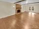 Open-concept living room with brick fireplace and view of french doors to the backyard at 6813 Linda Lake Dr, Charlotte, NC 28215
