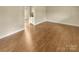 Empty room featuring hardwood floors, neutral colored walls and bright lighting at 6813 Linda Lake Dr, Charlotte, NC 28215