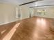 Large living room with exposed beams and view of a bathroom and exterior of the house at 6813 Linda Lake Dr, Charlotte, NC 28215