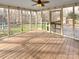 The screened porch has a wood plank floor and a view of the backyard at 6813 Linda Lake Dr, Charlotte, NC 28215
