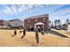 A well-maintained backyard featuring a brick home, a gazebo, and a lush green lawn at 815 Oak Embers Se Dr, Concord, NC 28025