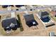 Aerial view of backyard features a patio and nearby pool in a well-maintained neighborhood at 815 Oak Embers Se Dr, Concord, NC 28025