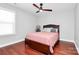 Bright bedroom featuring ceiling fan, wooden floors, and natural light from the window at 815 Oak Embers Se Dr, Concord, NC 28025