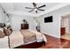 Spacious bedroom featuring tray ceiling, hardwood floors, ceiling fan and ensuite bathroom access at 815 Oak Embers Se Dr, Concord, NC 28025