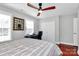 Cozy bedroom with a ceiling fan, natural light, and a dedicated workspace at 815 Oak Embers Se Dr, Concord, NC 28025