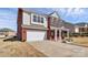 Well-maintained two-story home featuring a spacious driveway, a two-car garage, and a charming front porch at 815 Oak Embers Se Dr, Concord, NC 28025