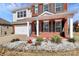 Charming two-story brick home featuring a well-manicured lawn, covered porch, and attached two-car garage at 815 Oak Embers Se Dr, Concord, NC 28025