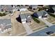 Aerial view showcases a well-manicured front lawn and a two-car garage at 815 Oak Embers Se Dr, Concord, NC 28025