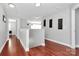 Bright hallway with wood floors and neutral paint, offering access to various rooms in the home at 815 Oak Embers Se Dr, Concord, NC 28025