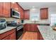 Modern kitchen with granite countertops, a gas range, and ample cabinet space at 815 Oak Embers Se Dr, Concord, NC 28025