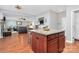 Kitchen island boasts granite countertops and wooden cabinets, blending style and functionality at 815 Oak Embers Se Dr, Concord, NC 28025