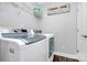 Well-equipped laundry room with modern appliances, shelving, and sign at 815 Oak Embers Se Dr, Concord, NC 28025