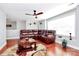 Comfortable living area with a brown leather sofa, ceiling fan, and lots of natural light at 815 Oak Embers Se Dr, Concord, NC 28025