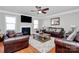 Cozy living room with a fireplace, large windows, and comfortable seating arrangement at 815 Oak Embers Se Dr, Concord, NC 28025