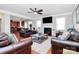 Spacious living room boasts hardwood floors, a fireplace, and comfortable seating, adjacent to a modern kitchen at 815 Oak Embers Se Dr, Concord, NC 28025