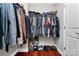Organized walk-in closet featuring hanging storage, shelving and shoe racks for optimal storage solutions at 815 Oak Embers Se Dr, Concord, NC 28025