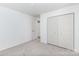 Bright bedroom featuring neutral carpet, closet, and fresh white paint at 8322 Knights Bridge Rd, Charlotte, NC 28210