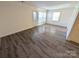 Well-lit living room with wood-look flooring and a glass-paneled exterior door at 8322 Knights Bridge Rd, Charlotte, NC 28210