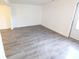 Neutral living room featuring wood-look flooring and natural light at 8322 Knights Bridge Rd, Charlotte, NC 28210