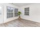 Bright and spacious living room featuring luxury vinyl flooring and two windows at 8322 Knights Bridge Rd, Charlotte, NC 28210