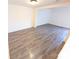 Spacious living room with modern wood-look flooring and neutral paint at 8322 Knights Bridge Rd, Charlotte, NC 28210