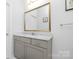 Bathroom featuring a gray vanity with a marble countertop and an elegant gold-framed mirror at 840 Imperial Ct, Charlotte, NC 28273