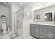 Modern bathroom featuring glass enclosed shower and double sink vanity with a white marble countertop at 840 Imperial Ct, Charlotte, NC 28273