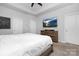 Bedroom with a ceiling fan, white walls, a wooden bed frame, and a TV mounted above the dresser at 840 Imperial Ct, Charlotte, NC 28273