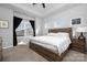 Bright bedroom with a tray ceiling, large window with curtains, and a wooden bed frame with white bedding at 840 Imperial Ct, Charlotte, NC 28273