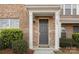 Inviting front entrance features a stylish gray door, brick facade, and manicured bushes at 840 Imperial Ct, Charlotte, NC 28273