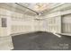 Unfinished two-car garage with partially finished walls and rubber-tile floor at 840 Imperial Ct, Charlotte, NC 28273