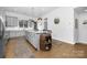 Spacious kitchen featuring gray cabinets, a central island with seating, and hardwood floors at 840 Imperial Ct, Charlotte, NC 28273