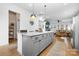 Modern kitchen island with pendant lighting, granite countertops, and seating for casual dining at 840 Imperial Ct, Charlotte, NC 28273