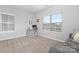 Living room featuring neutral walls, carpet flooring, a desk, and a couch at 840 Imperial Ct, Charlotte, NC 28273