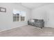 Living room featuring neutral walls, carpet flooring, a window, and a couch at 840 Imperial Ct, Charlotte, NC 28273