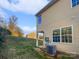 Side view of the backyard featuring green space and a home exterior with vinyl siding at 9154 Bradstreet Commons Way, Charlotte, NC 28215