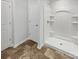 Bathroom with a walk-in shower featuring built-in shelving and a waterproof base at 9154 Bradstreet Commons Way, Charlotte, NC 28215