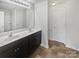 Well-lit bathroom with double sinks, spacious vanity, and modern fixtures at 9154 Bradstreet Commons Way, Charlotte, NC 28215