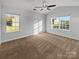 Bright bedroom with large windows offering natural light, carpeted floors, and a ceiling fan at 9154 Bradstreet Commons Way, Charlotte, NC 28215