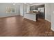 Open-concept kitchen with dark cabinetry and stainless steel appliances adjacent to the dining area at 9154 Bradstreet Commons Way, Charlotte, NC 28215